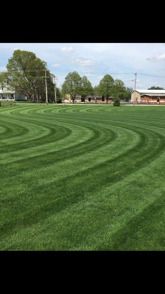 Large open property mowed and cleaned up with curved mowing stripes
